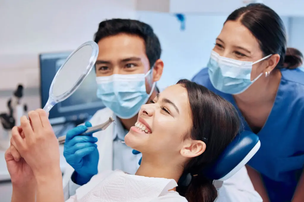 Shes excited about her new smile. a young woman checking her results in the dentists office